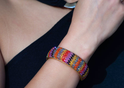 80DB Spectrum Symphony cuff featuring a vibrant multi-coloured crystal pattern that creates a bold visual symphony of red, yellow and striking hues