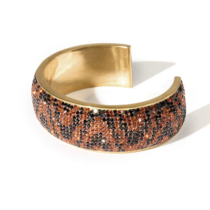 80DB Roaring Rhythm cuff with animal-inspired dark brown and black crystal stones in a wavy design